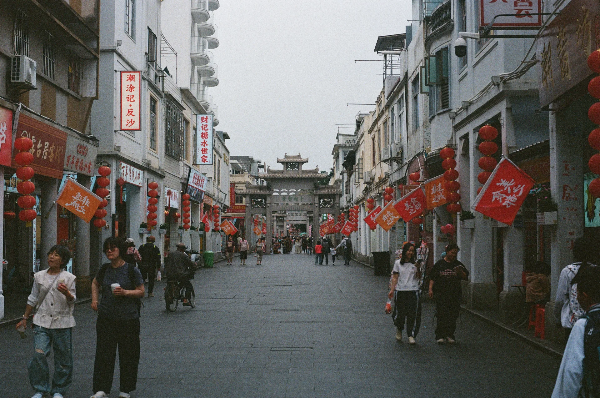A street in Chaozhou lined with red lanterns and traditional stone gateways