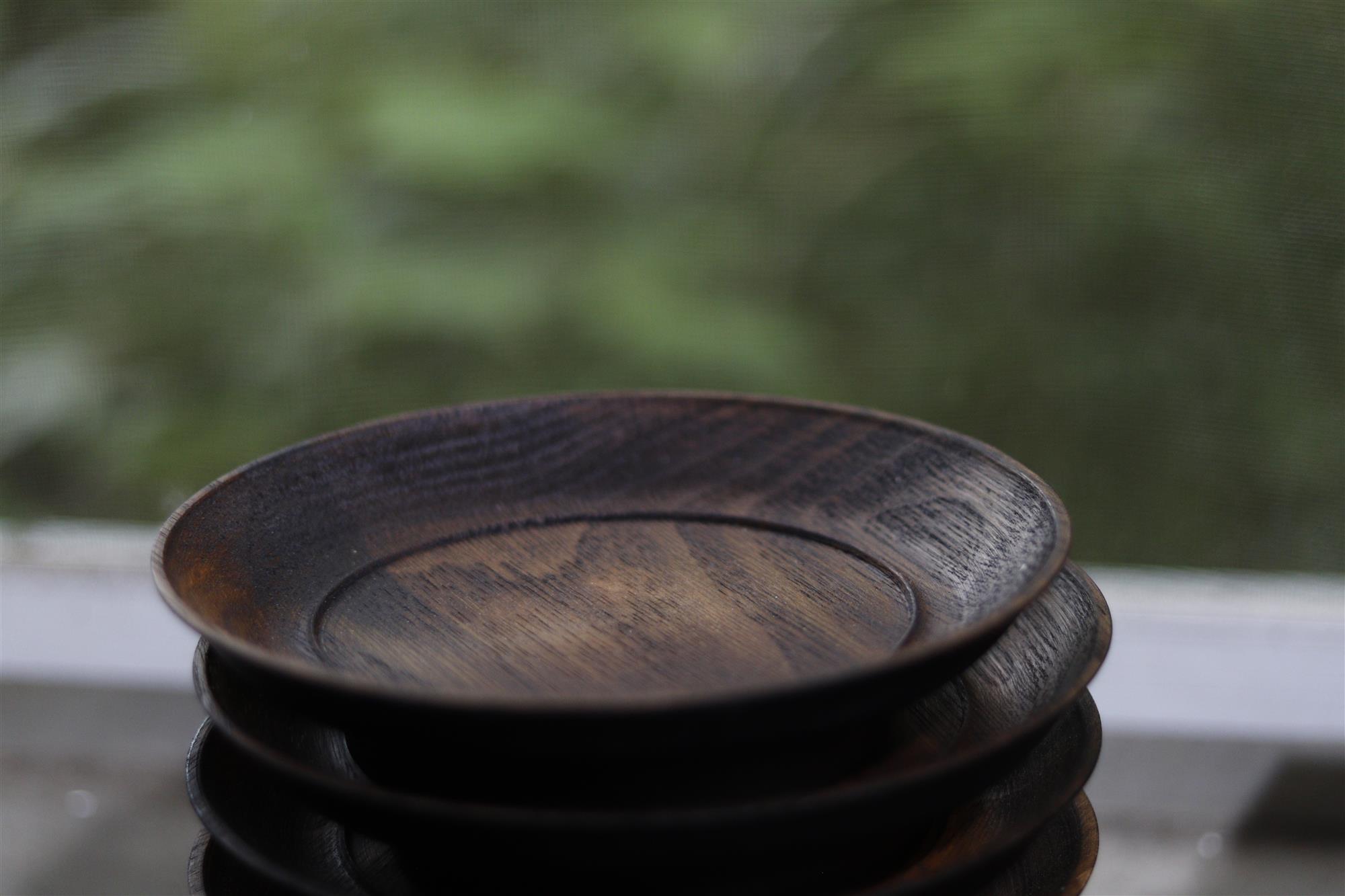 Stacked wooden bowls with visible grain and carved surfaces