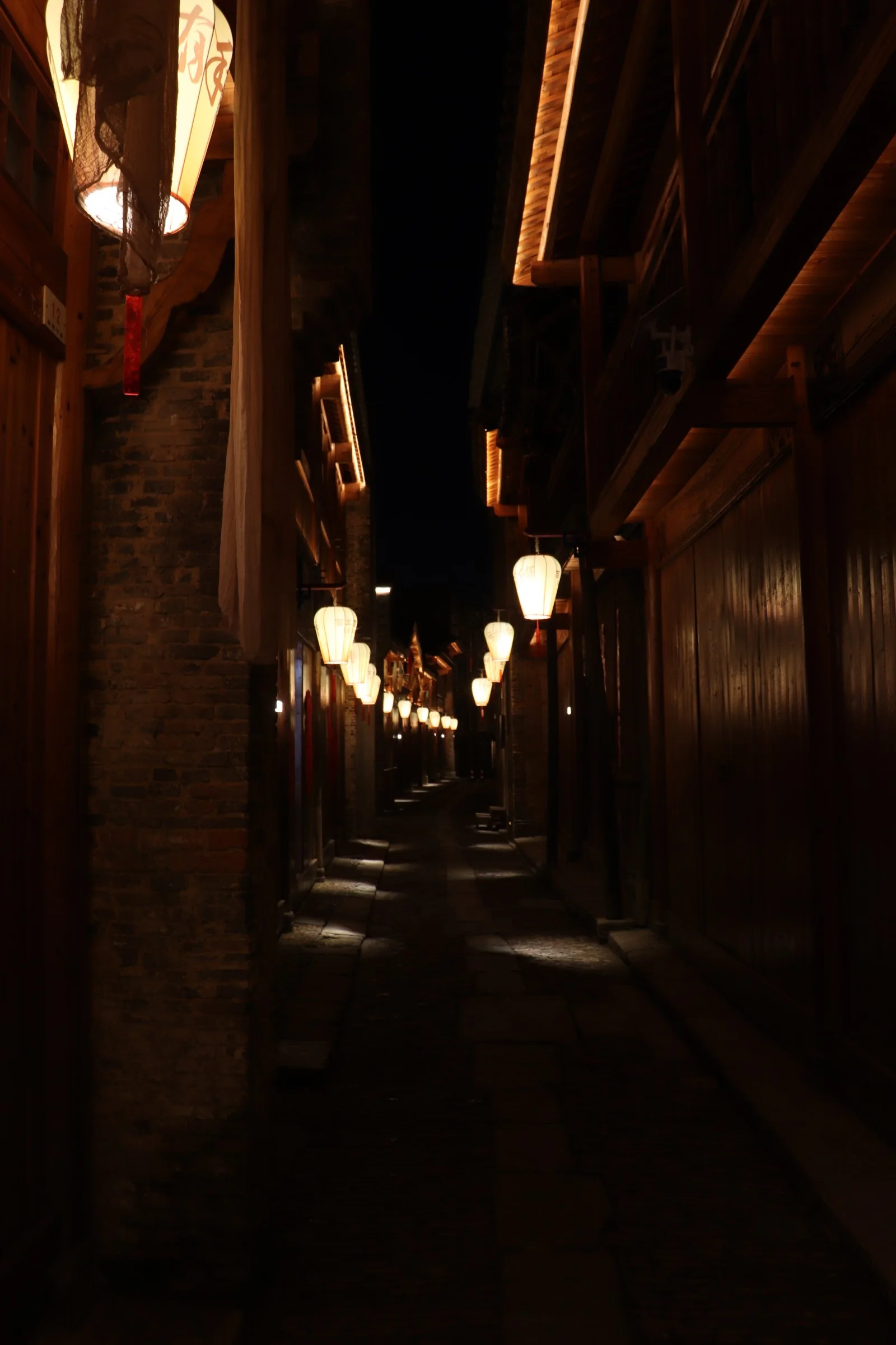 A lantern-lit street between traditional buildings in Jingdezhen