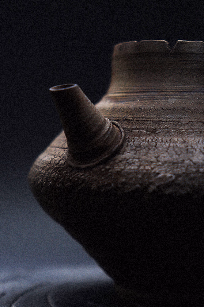 The teapot's spout and mineral-rich clay surface