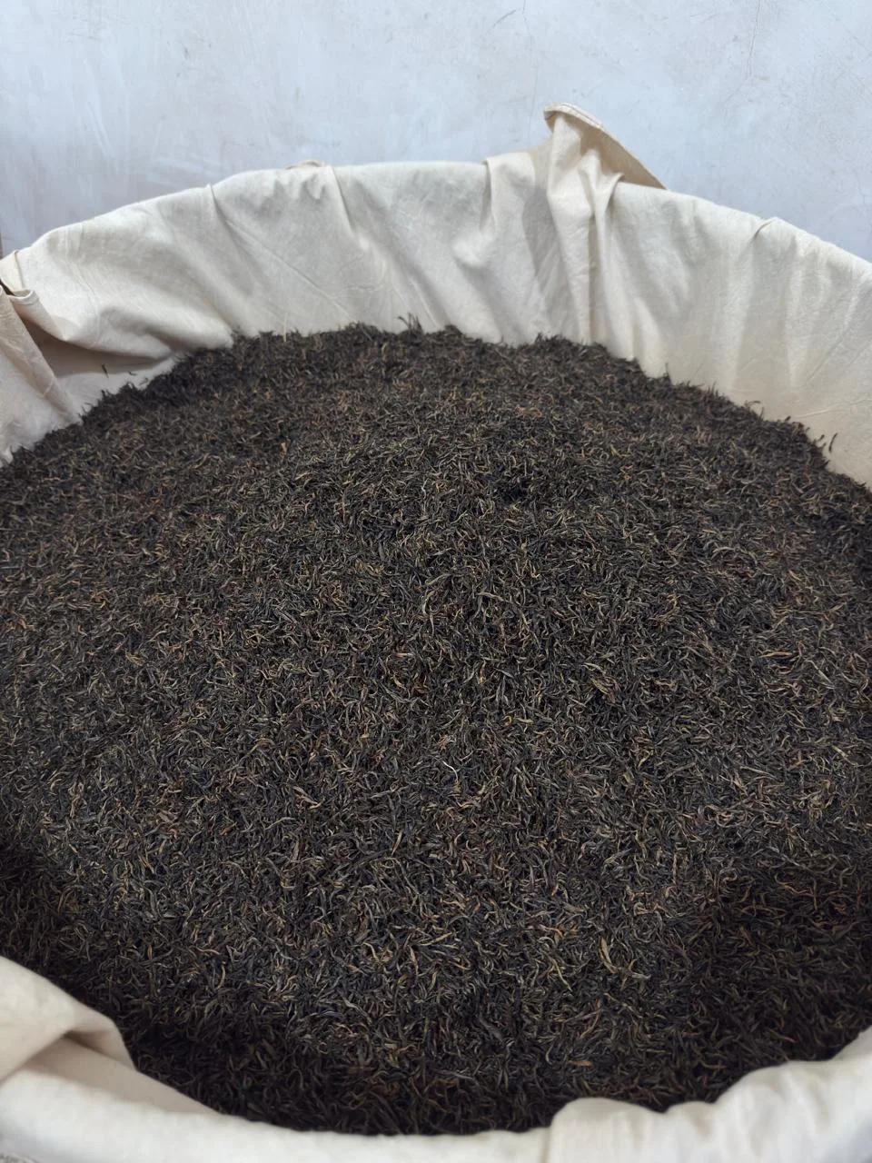 Finished tea leaves in a cloth-lined basket in Tongmu