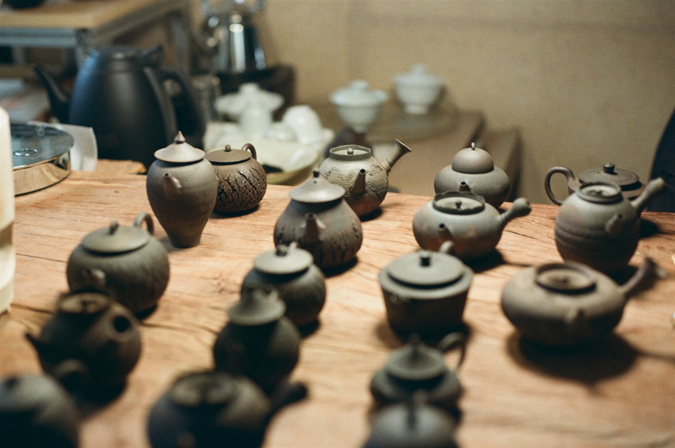 Different teapot forms and surfaces on the studio table